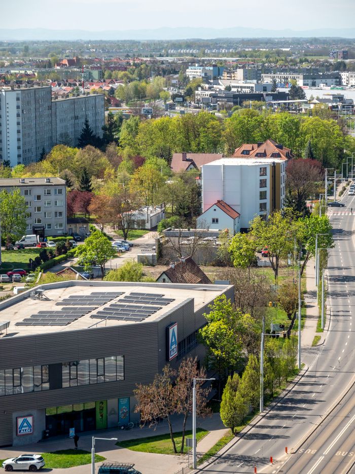 Aerial view of Wrocław suburban area with modern and traditional buildings.