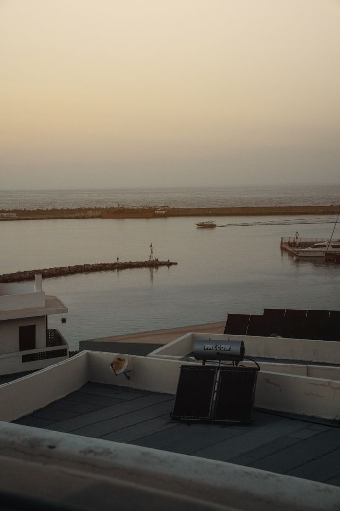 The Art of Drawing Readers In: Your attractive post title goes here Serene coastal scene at sunset featuring a rooftop solar panel and tranquil waters.
