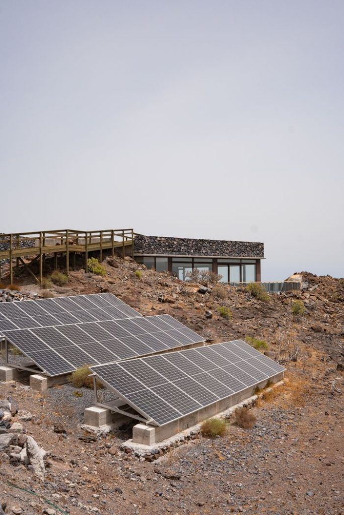 Solar panels installed on a rocky hillside showcasing renewable energy in Spain.